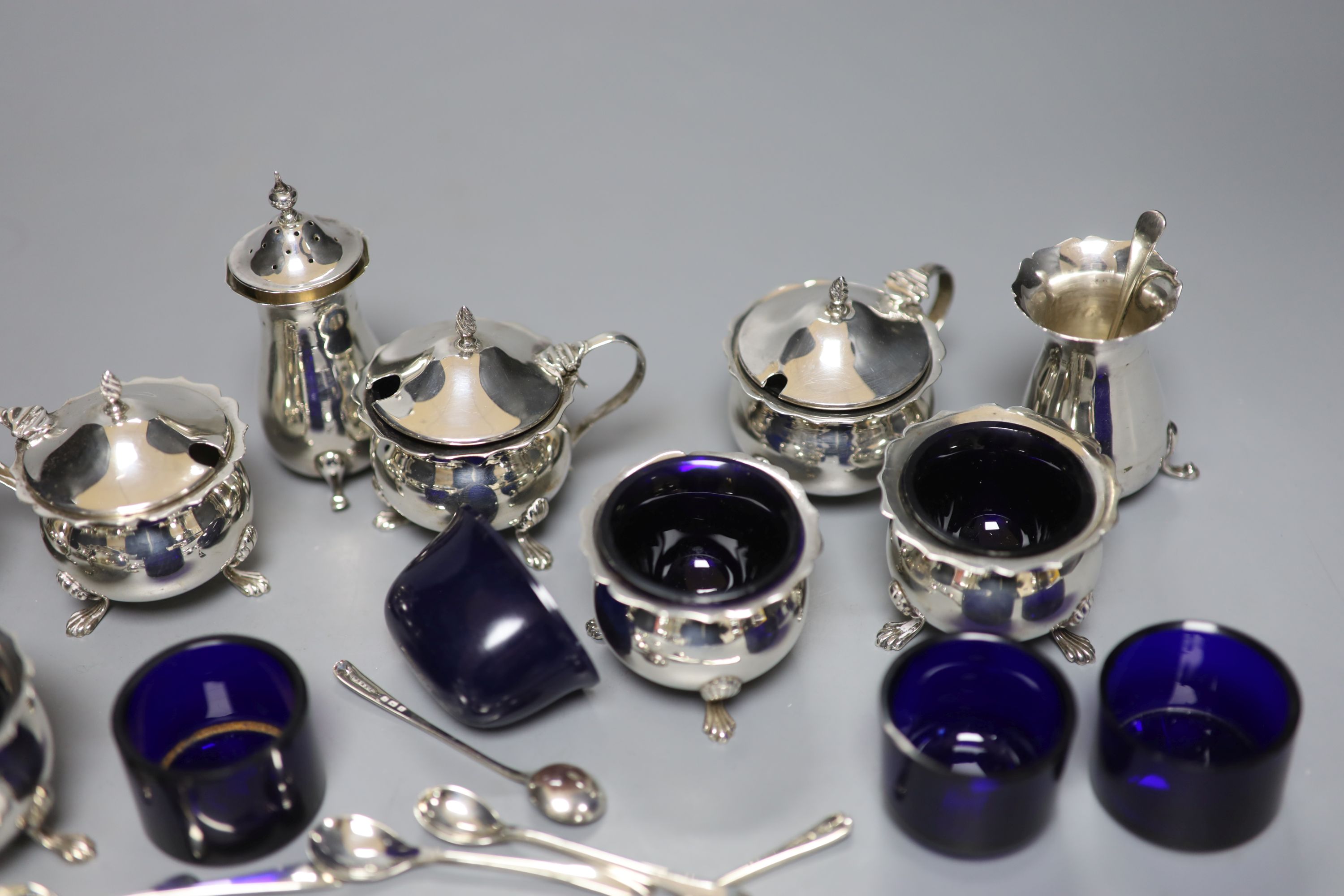 An Edwardian six piece silver condiment set and five other assorted silver condiments.